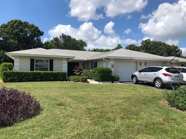 ranch-style home with a front lawn and a garage