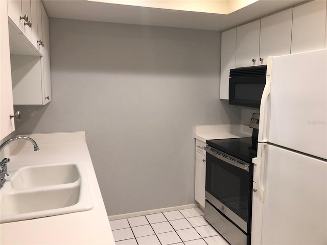 kitchen with white fridge, white cabinetry, stainless steel range with electric cooktop, and sink