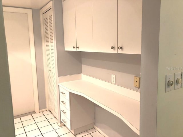 kitchen featuring light tile patterned floors and white cabinetry