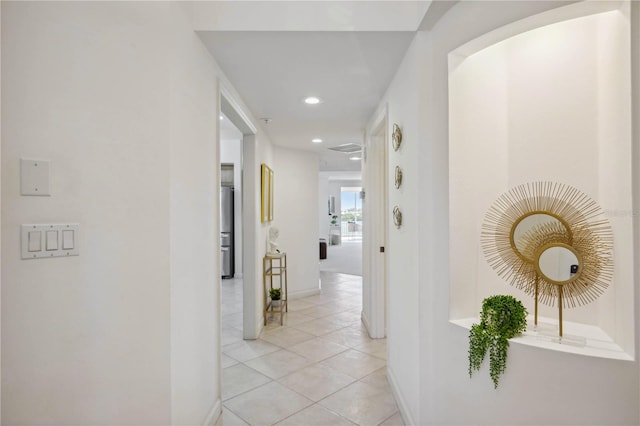 hallway with light tile patterned floors