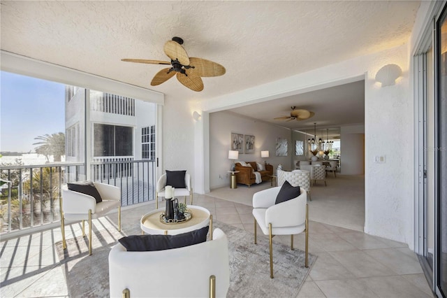 interior space with a textured ceiling and ceiling fan