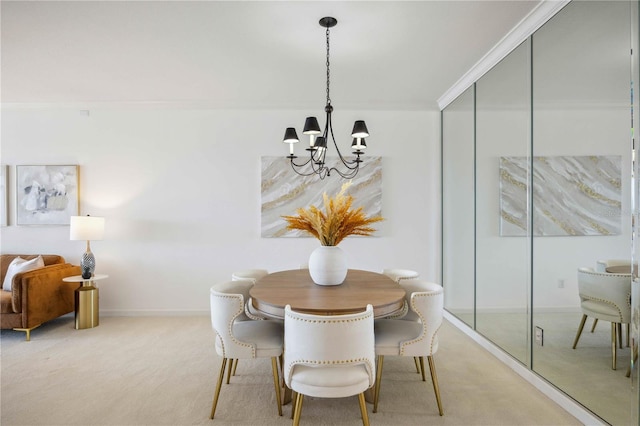 dining room featuring carpet flooring, ornamental molding, and an inviting chandelier