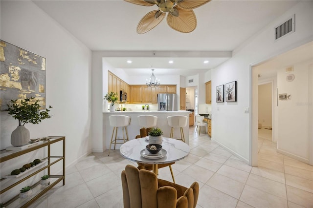 interior space with light tile patterned floors and ceiling fan with notable chandelier