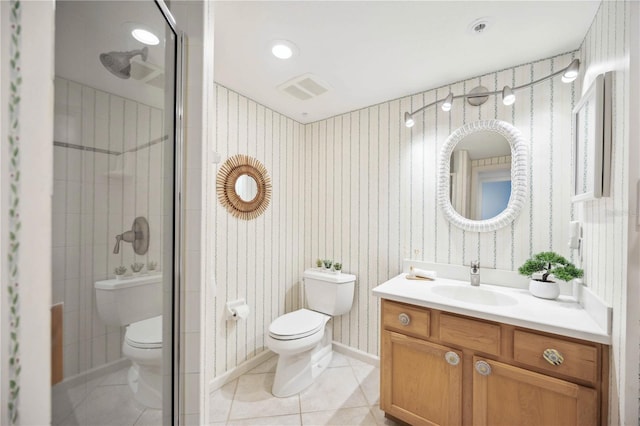 bathroom with tile patterned floors, vanity, walk in shower, and toilet