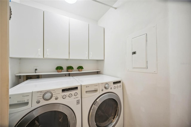 laundry area with cabinets, electric panel, and washer and clothes dryer