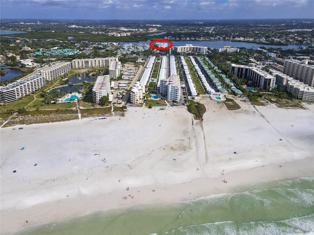 drone / aerial view with a water view and a view of the beach