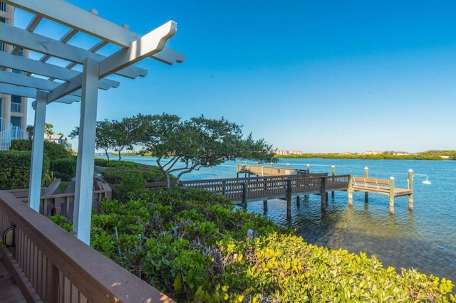 dock area featuring a pergola and a water view