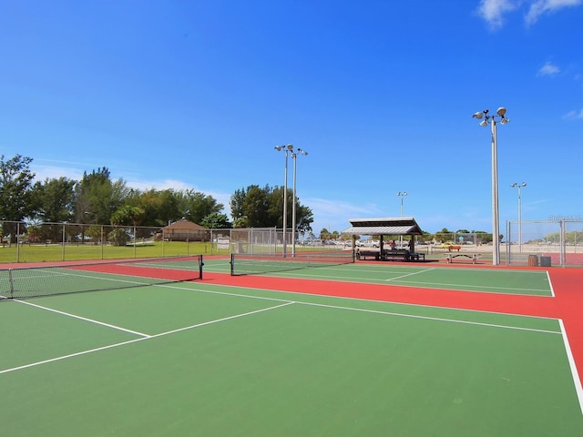 view of tennis court with basketball hoop