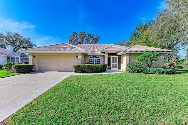 view of front of house with a front yard and a garage