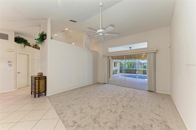 spare room with ceiling fan, light tile patterned floors, and high vaulted ceiling