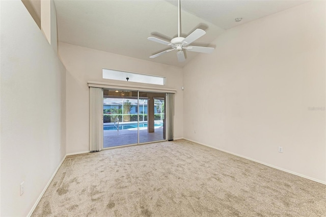 empty room featuring light carpet, vaulted ceiling, and ceiling fan