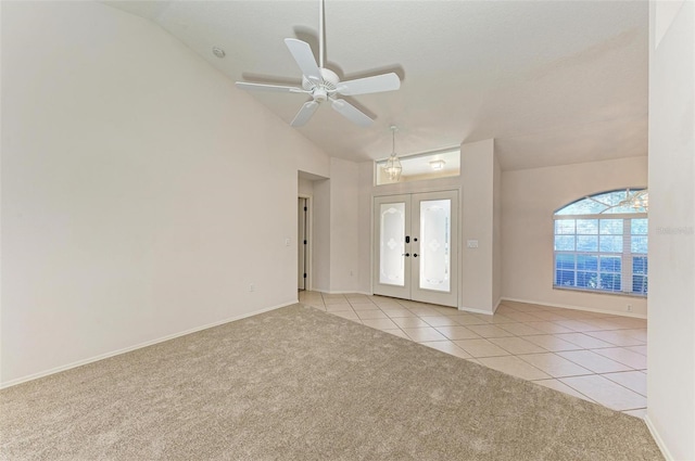 tiled entrance foyer featuring french doors, ceiling fan, and lofted ceiling