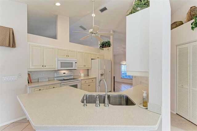 kitchen with white appliances, sink, ceiling fan, light tile patterned floors, and tasteful backsplash