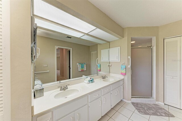 bathroom featuring tile patterned floors, vanity, and an enclosed shower