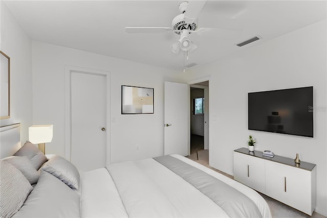 bedroom with ceiling fan and light carpet