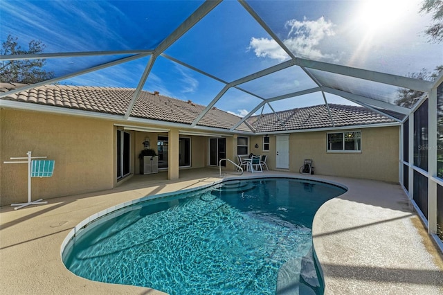 view of pool with a patio and a lanai