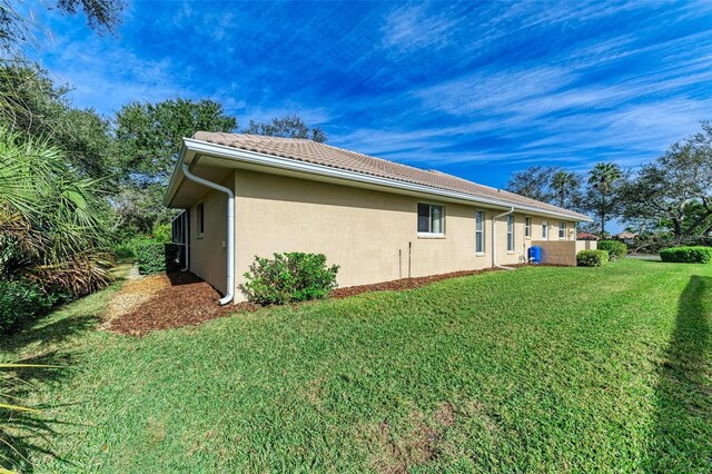 view of home's exterior with a lawn