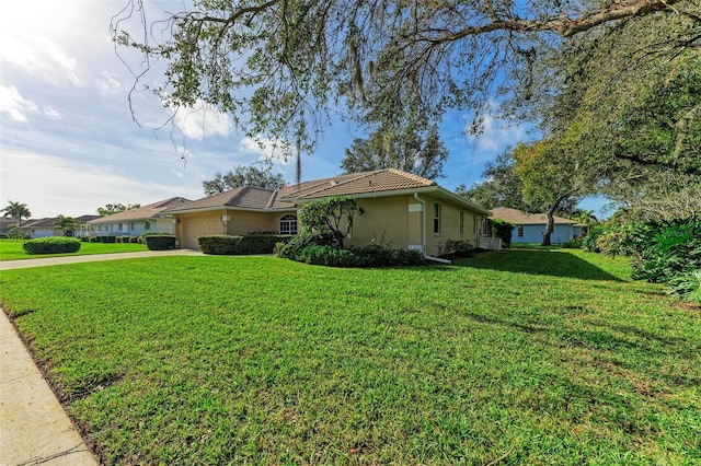 view of property exterior featuring a garage and a lawn