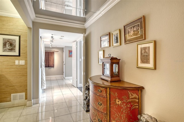 hall with crown molding and light tile patterned flooring