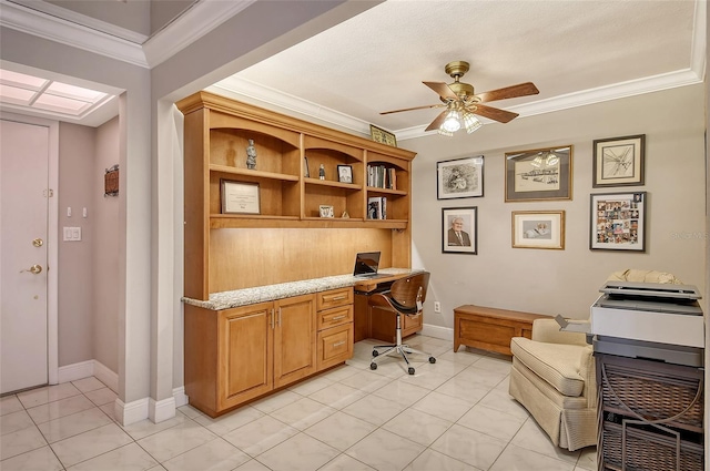 office area featuring ceiling fan, light tile patterned flooring, built in desk, and ornamental molding