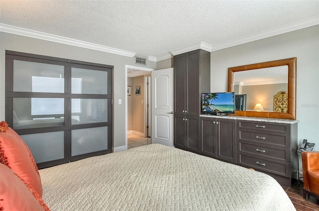 bedroom with a textured ceiling and ornamental molding