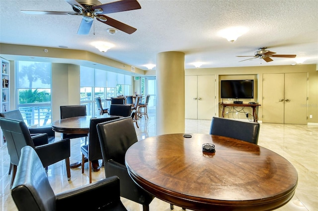 dining area featuring a textured ceiling, ceiling fan, and light tile patterned flooring