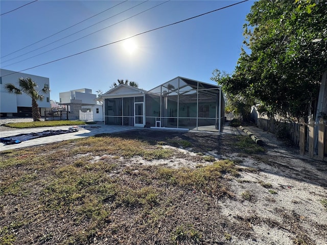 rear view of property with glass enclosure