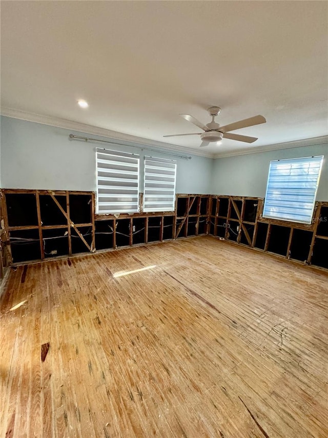 misc room featuring ceiling fan, wood-type flooring, and crown molding