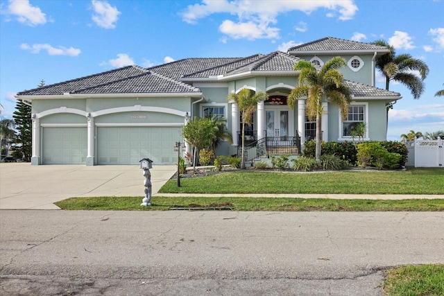 mediterranean / spanish home with a front yard and a garage