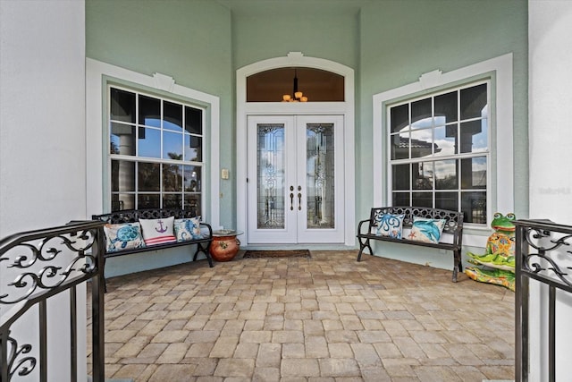 property entrance featuring french doors and a porch