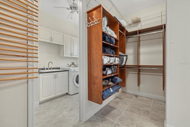 clothes washing area with ceiling fan, cabinets, sink, and washer / clothes dryer