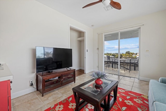 living room with ceiling fan and light tile patterned floors