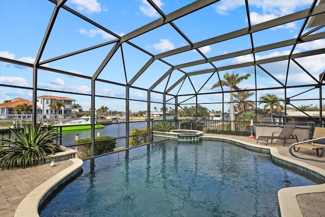 view of swimming pool featuring an in ground hot tub, a patio, a water view, and a lanai