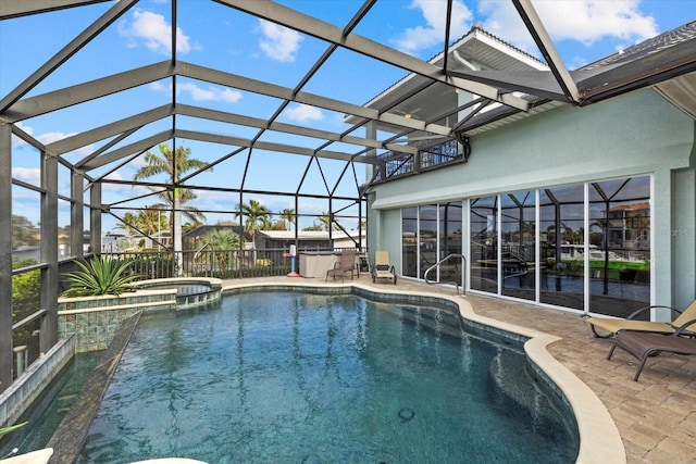 view of pool with a lanai, a patio area, and an in ground hot tub