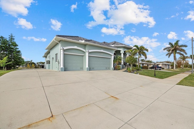 view of front of property with a garage and a front lawn