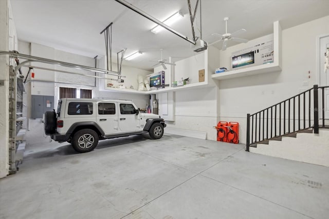 garage with electric panel, ceiling fan, and a garage door opener