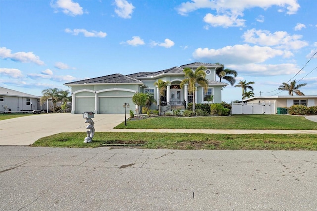 mediterranean / spanish-style house featuring a front lawn and a garage