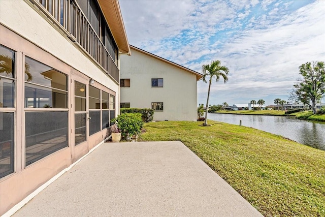 view of yard with a patio area and a water view