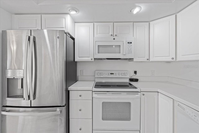 kitchen with white cabinetry and white appliances