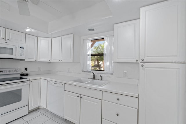 kitchen featuring white appliances, white cabinetry, and sink