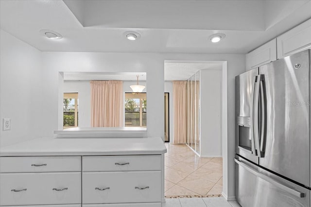 kitchen with white cabinets, decorative light fixtures, and stainless steel refrigerator with ice dispenser