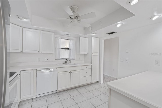 kitchen with dishwasher, light tile patterned flooring, white cabinetry, and range