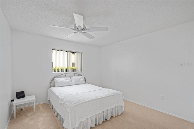 carpeted bedroom with ceiling fan and a textured ceiling