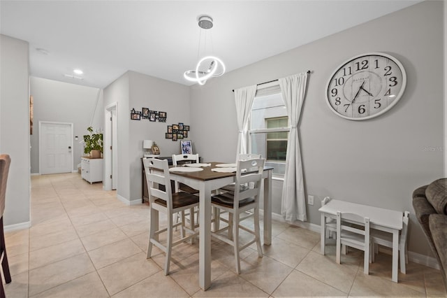 dining room featuring a chandelier and light tile patterned floors