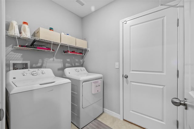 clothes washing area featuring washer and clothes dryer