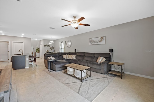 tiled living room featuring sink and ceiling fan