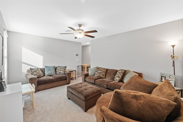 carpeted living room featuring ceiling fan