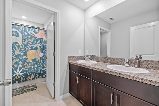 bathroom with tile patterned floors, shower / bath combo, and vanity