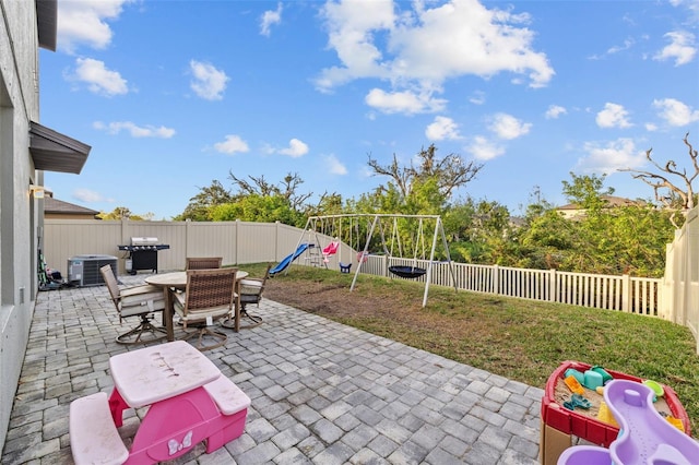 view of patio featuring a playground and area for grilling