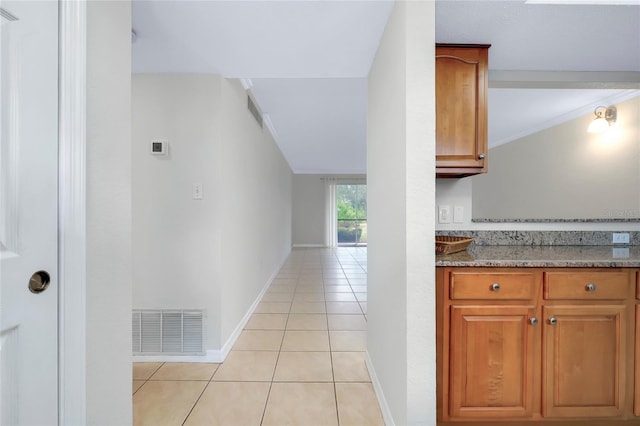 interior space with light stone counters and light tile patterned floors